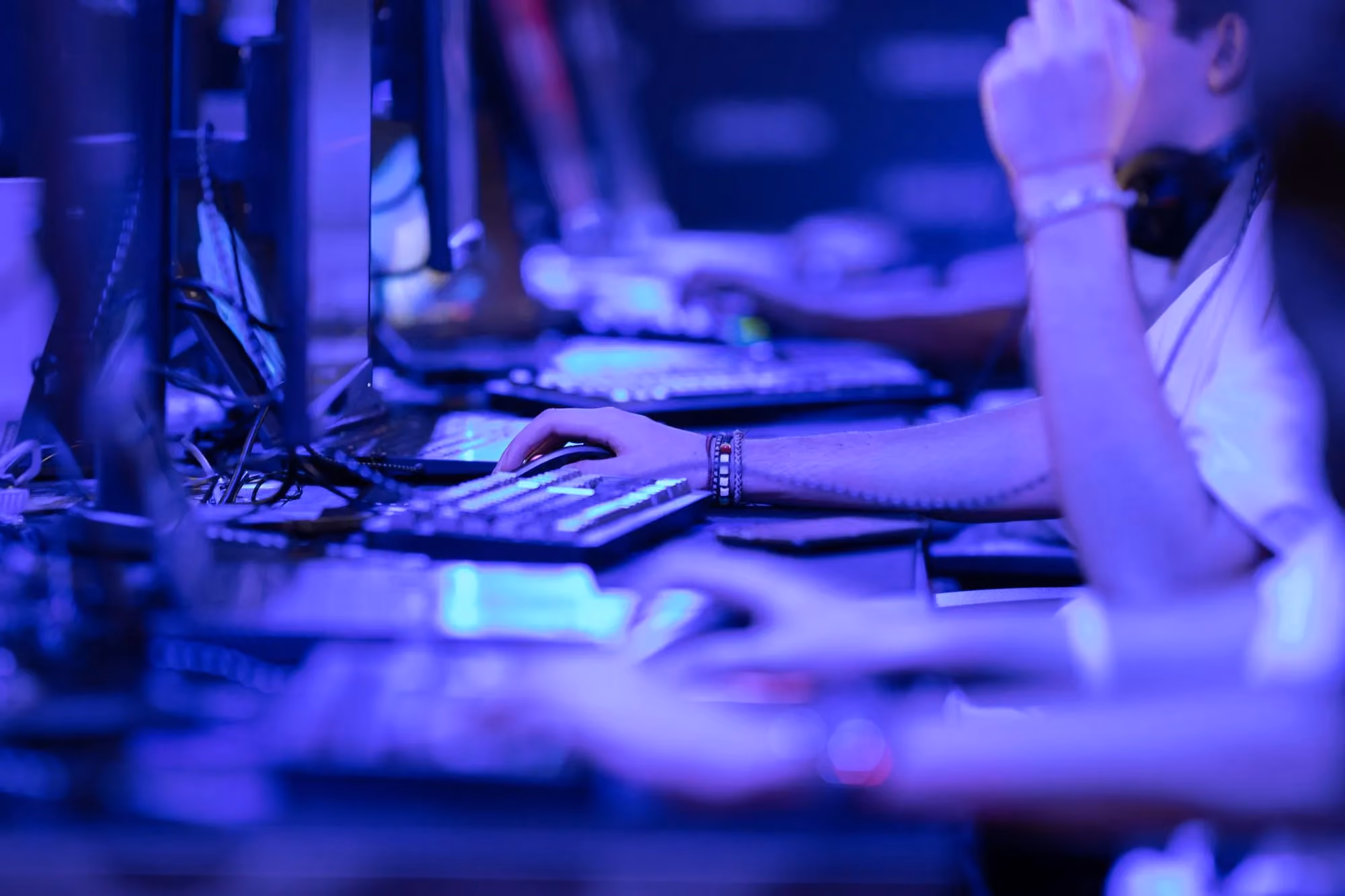 IT team working at computers in a dimly lit operations room