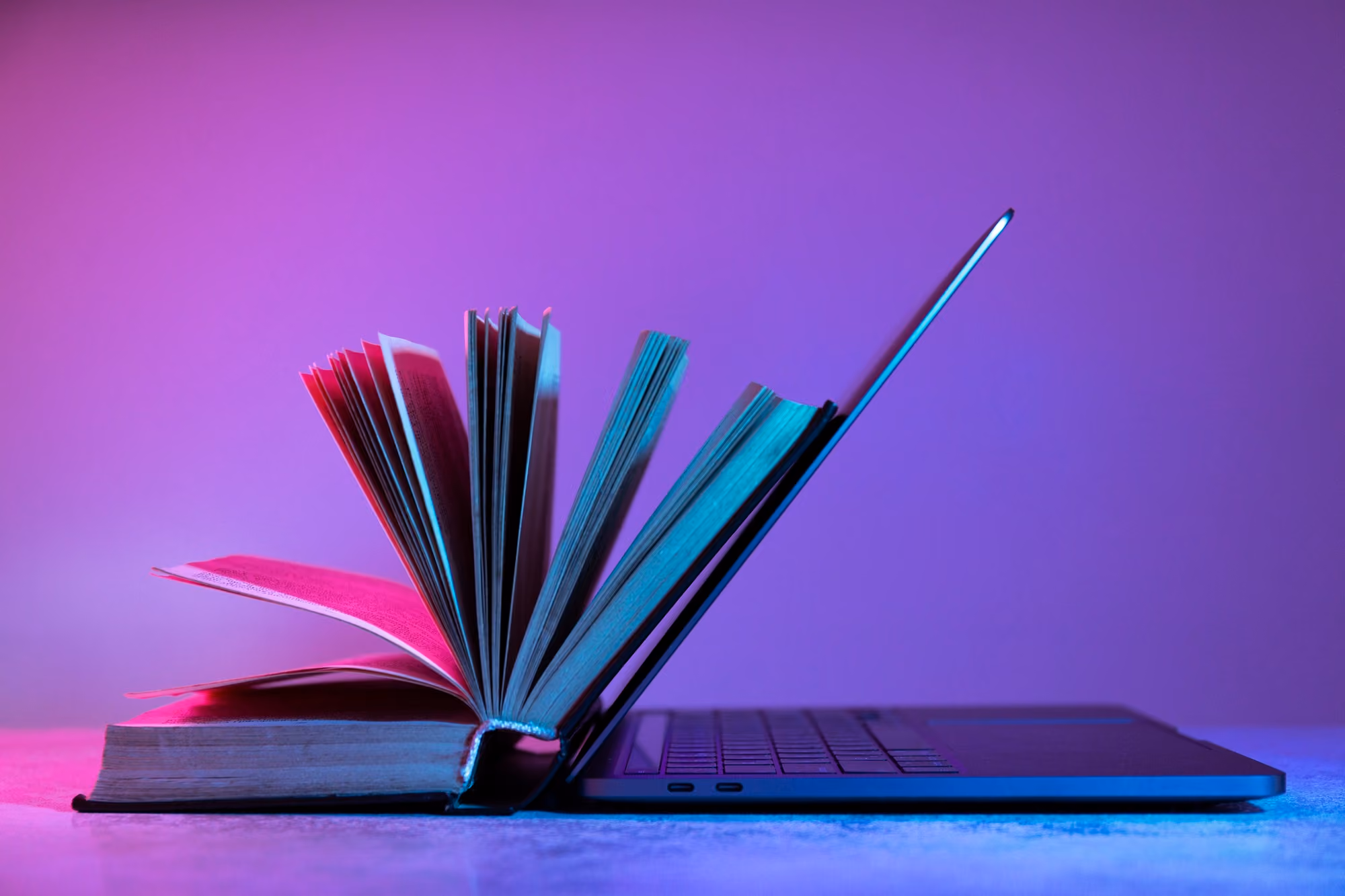 Open book resting on a laptop, representing cybersecurity education
