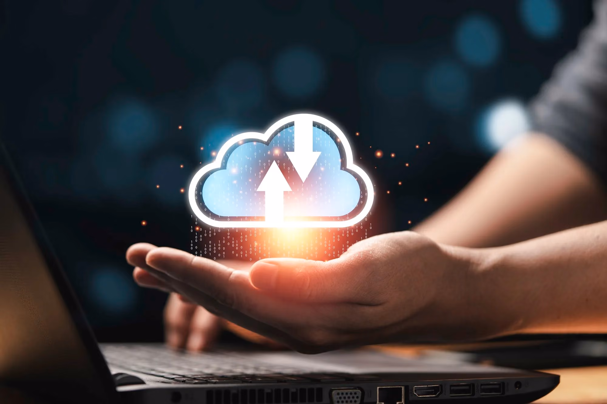 Hand holding a glowing cloud icon representing cloud computing