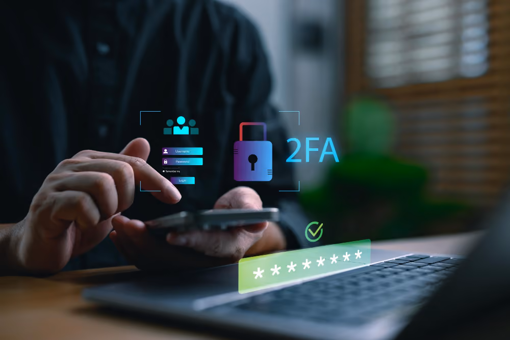 Person signing in on a laptop with two-factor authentication prompts